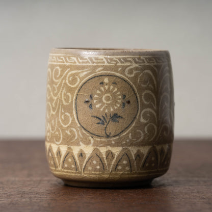 Goryeo Rice-colored Celadon Cylindrical Tea Bowl with Inlaid Chrysanthemum Design